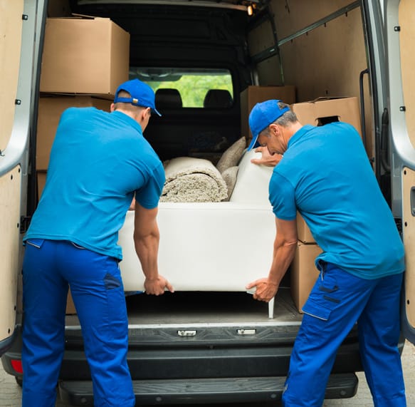 Retail delivery drivers load office furniture