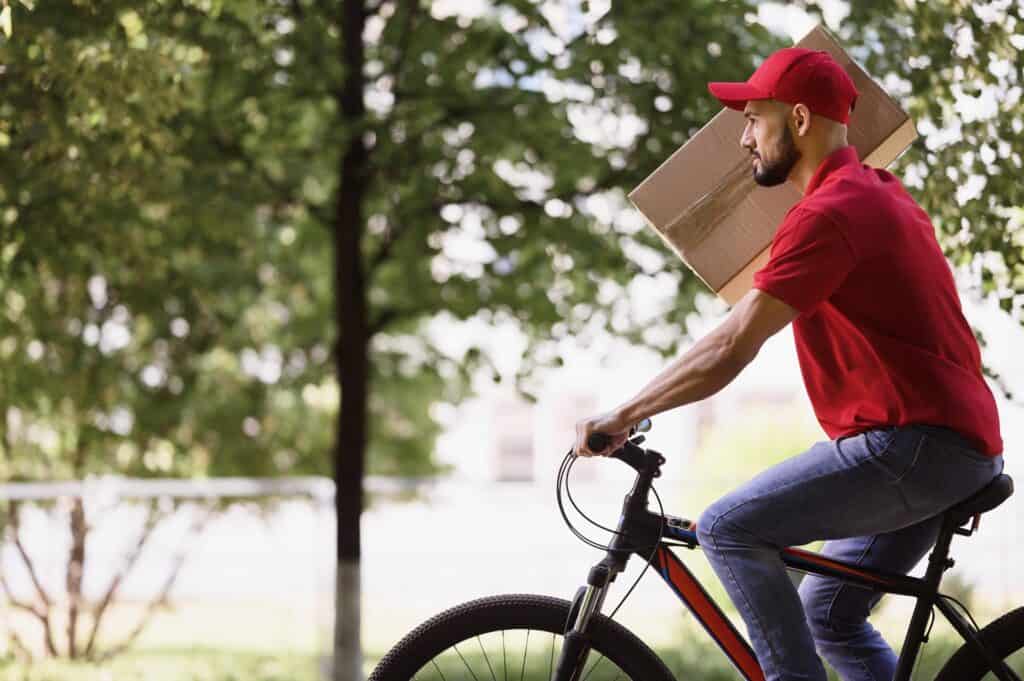 Independent courier carrying a parcel on a bike for delivery