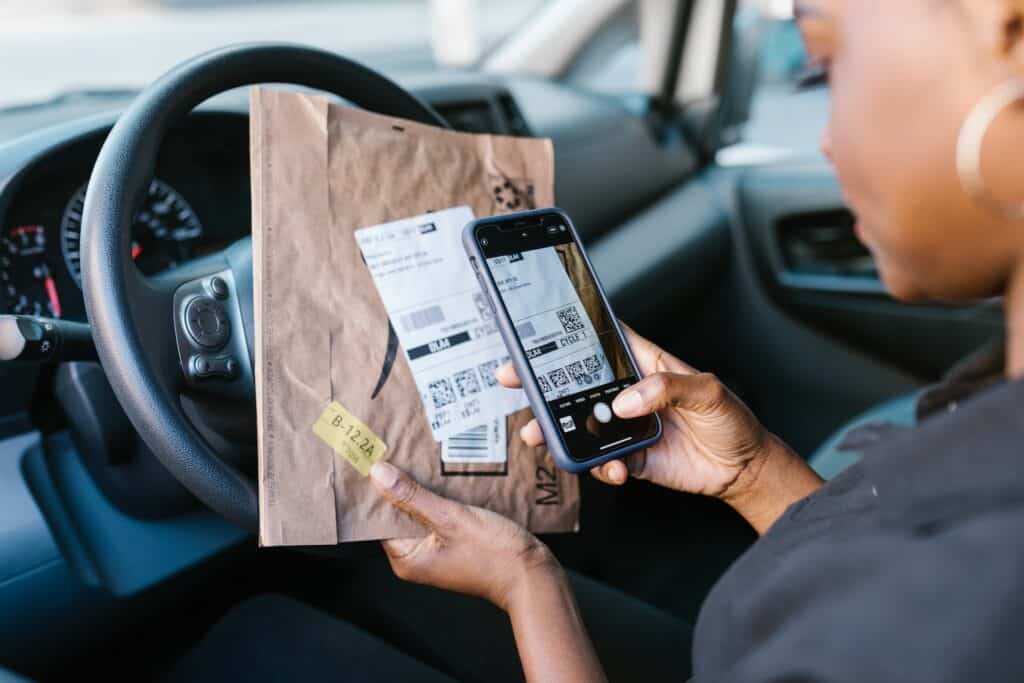 Person Holding a Cellphone and Parcel