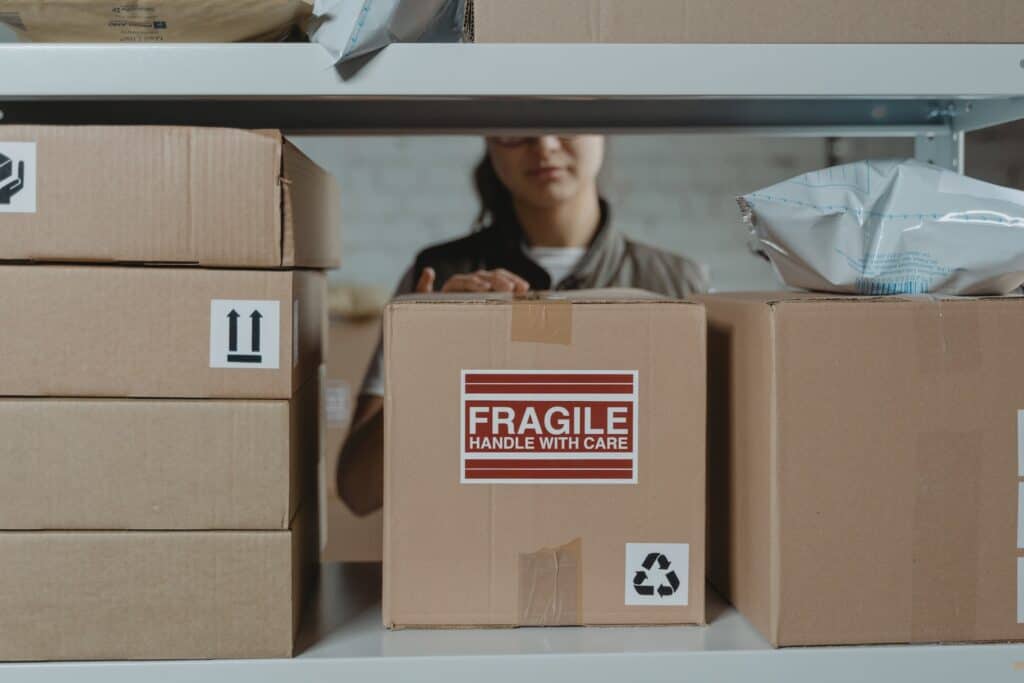 Worker at a distribution center sorting packages for last-mile delivery