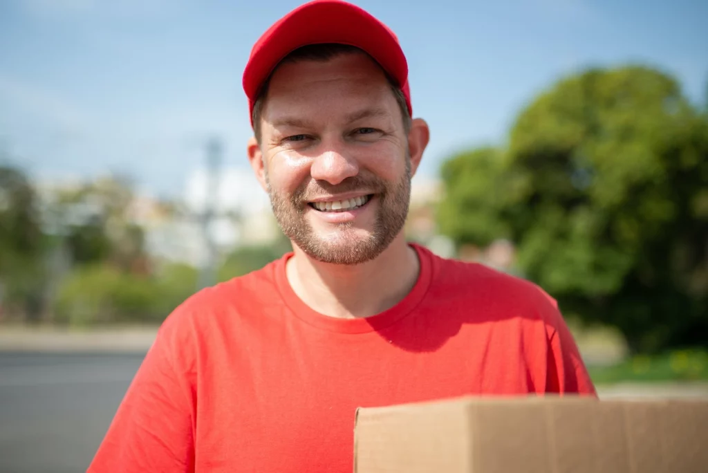 Smiling delivery driver with a package