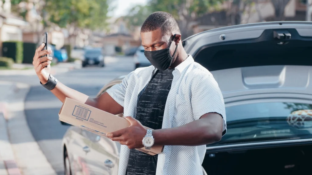 Delivery driver checking delivery address before delivering package