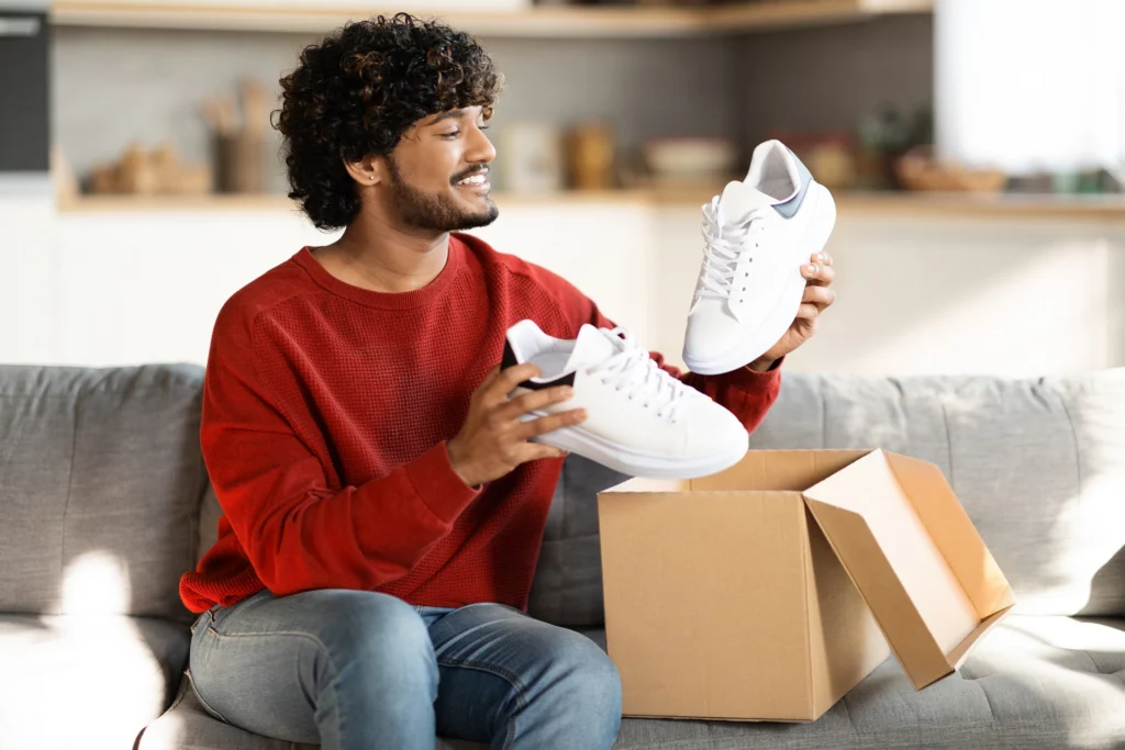 Happy customer opening sneakers from same-day delivery or instant fulfillment