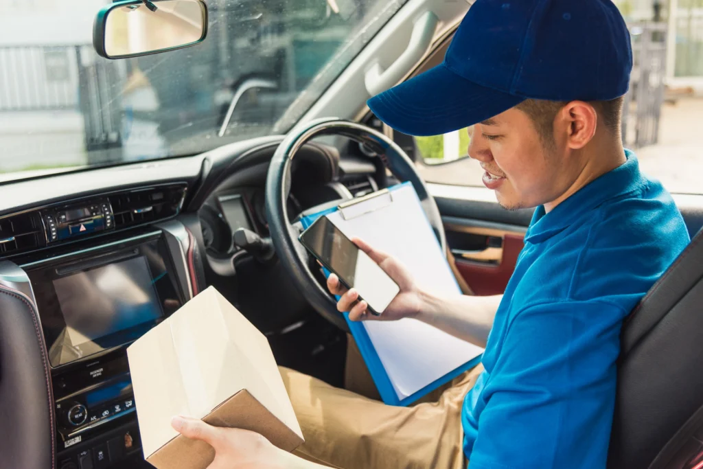 Delivery driver reviewing delivery information on a smartphone